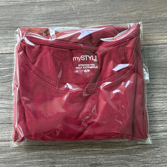 Woman’s long sleeved stretch tee. Has a small faint stain. Shown in photos. - Picture 6 of 6